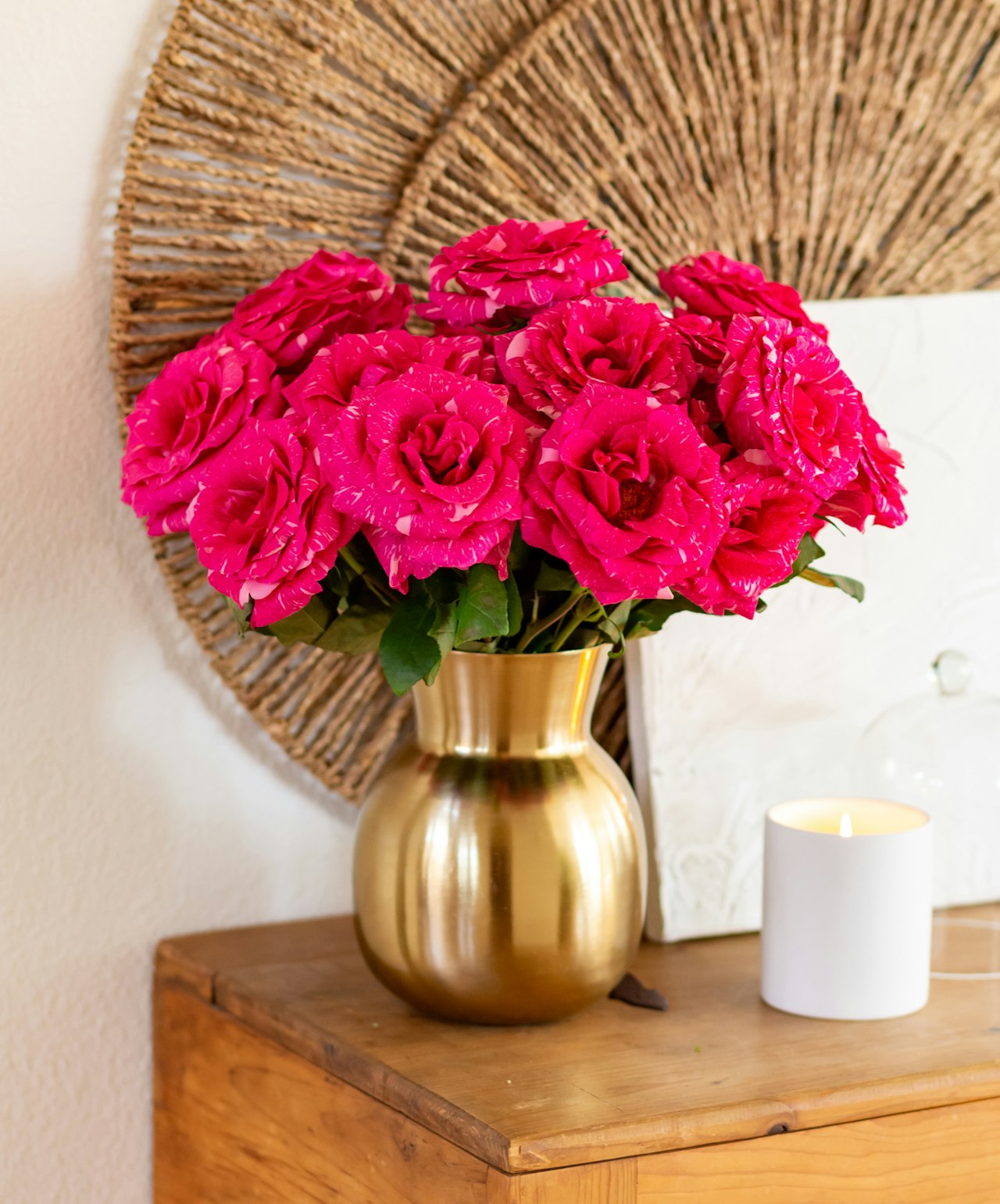 Vibrant pink roses in a golden vase, enhancing home decor with elegance and charm.