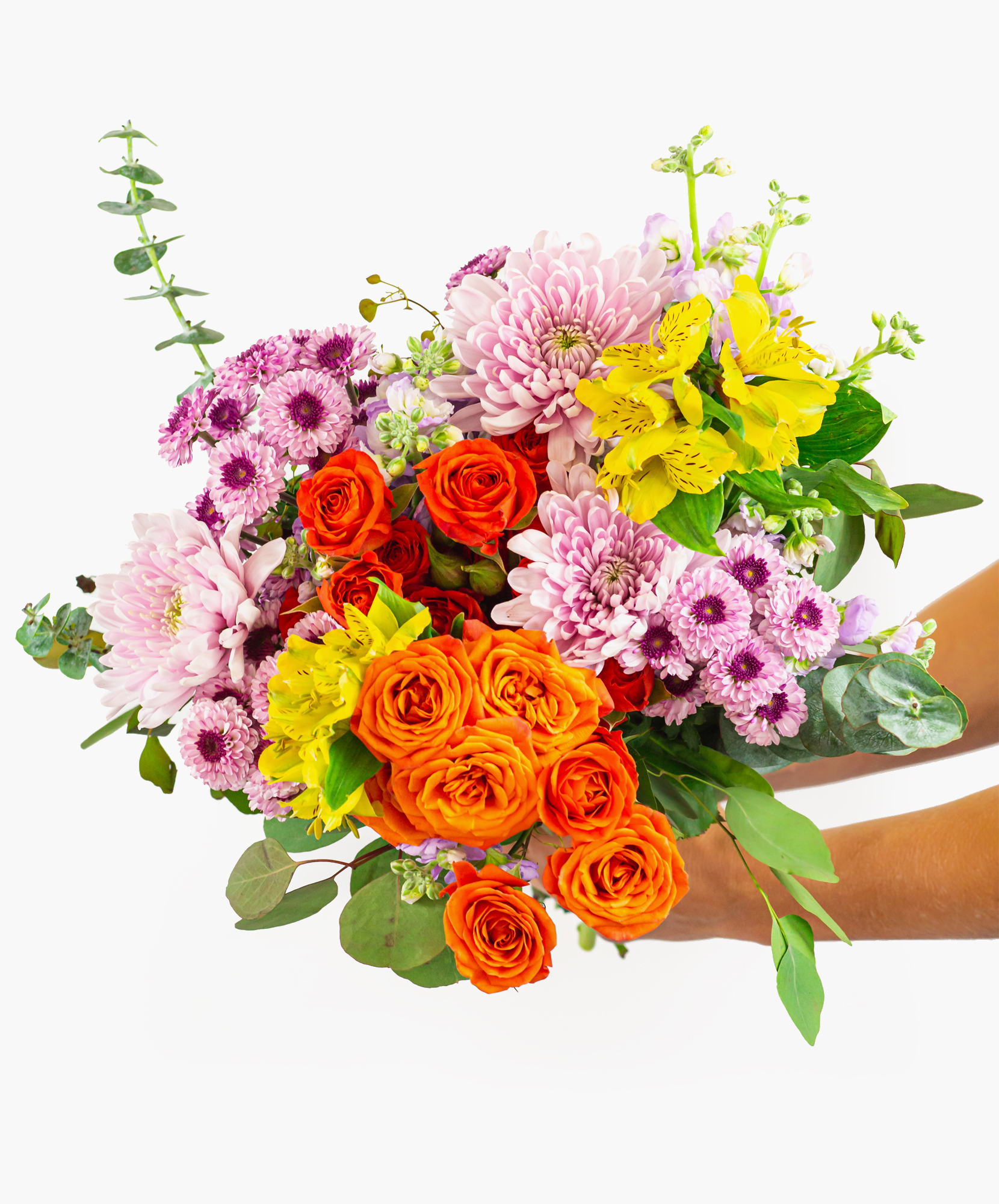 Vibrant bouquet featuring pink chrysanthemums, oranges roses, and yellow lilies, elegantly arranged.