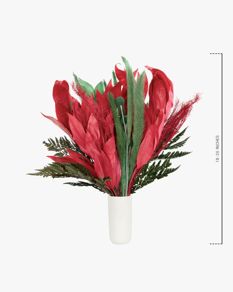 Bright red and green artificial floral arrangement in a white vase against a white background with a measurement scale indicating the bouquet's height.