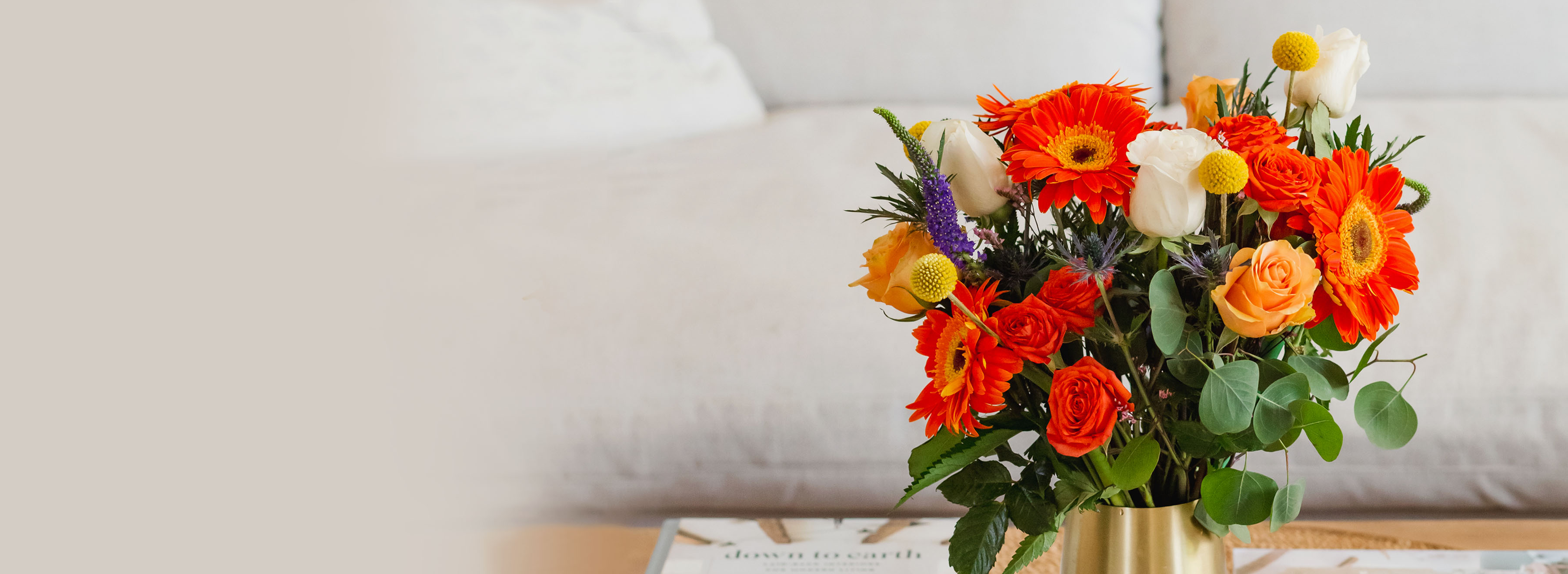 Vibrant bouquet featuring orange gerbera daisies and roses, perfect for brightening any space.