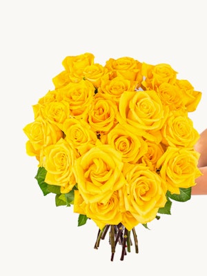Vibrant bouquet of bright yellow roses held elegantly, perfect for celebrations and gifts.