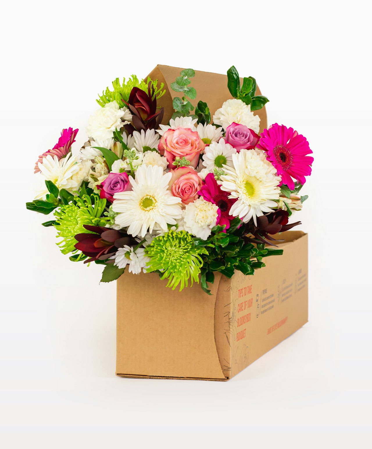 Vibrant bouquet featuring pink roses, white daisies, and green accents in a gift box.