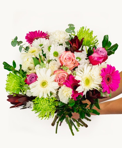 Vibrant bouquet featuring pink roses, white daisies, and green accents, perfect for celebrations.