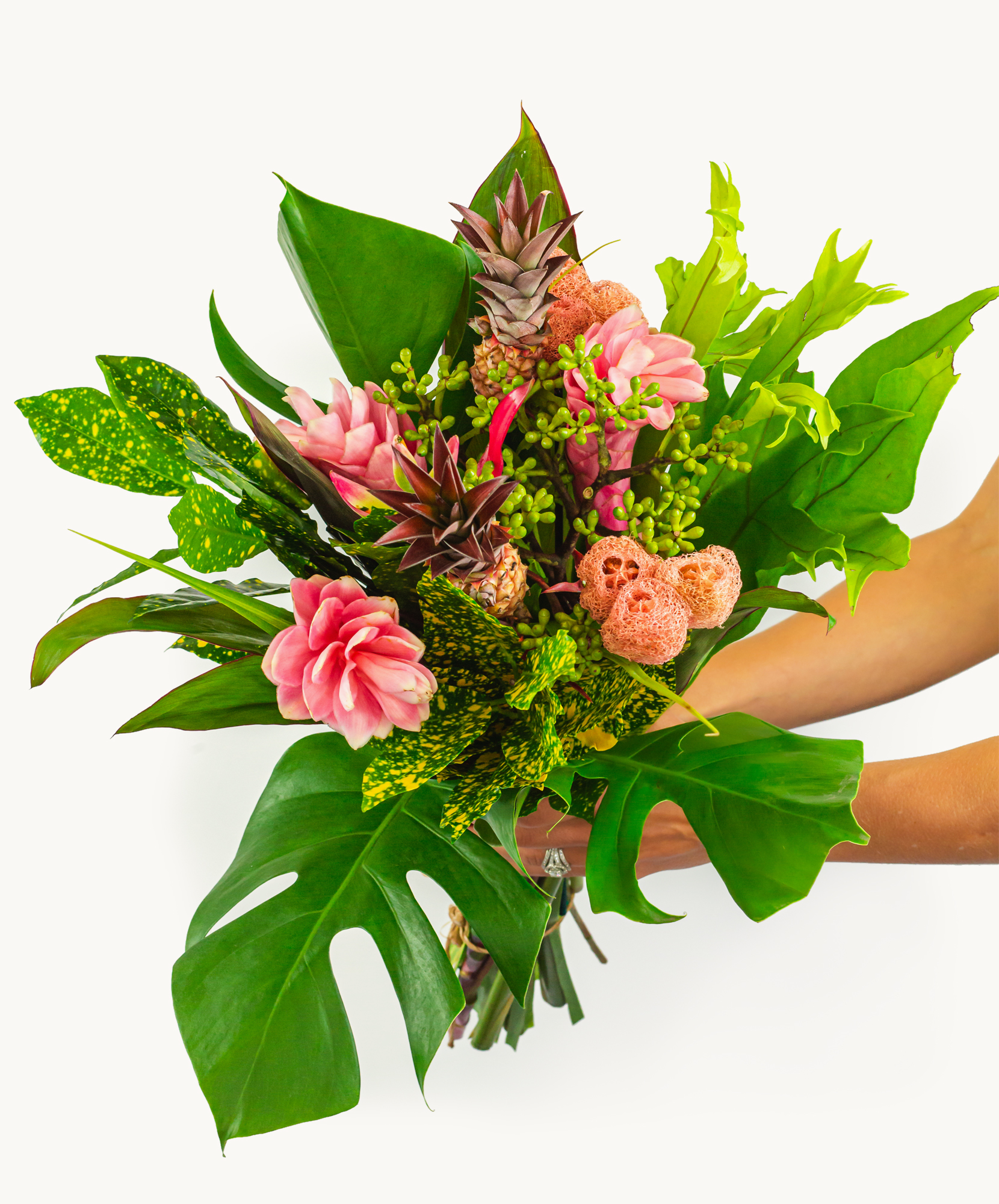 Vibrant tropical bouquet featuring pink flowers and lush green foliage, perfect for celebrations.