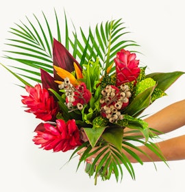 Vibrant tropical flower bouquet featuring red ginger, birds of paradise, and lush greenery.