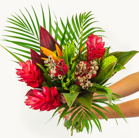 Vibrant tropical flower bouquet featuring red ginger, birds of paradise, and lush greenery.