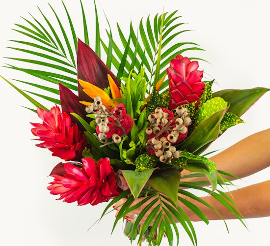 Vibrant tropical flower bouquet featuring red ginger, birds of paradise, and lush greenery.
