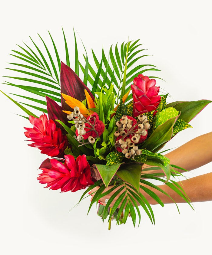Vibrant tropical flower bouquet featuring red ginger, birds of paradise, and lush greenery.