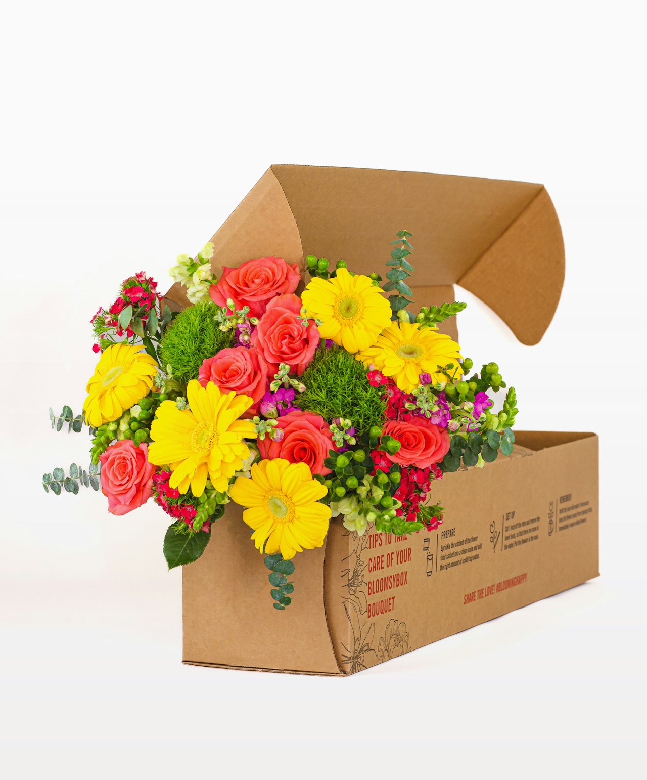 Vibrant floral arrangement featuring roses, gerberas, and greenery in a stylish packaging box.