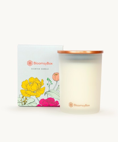 Elegant scented candle in a frosted glass jar, accompanied by a beautifully designed box.