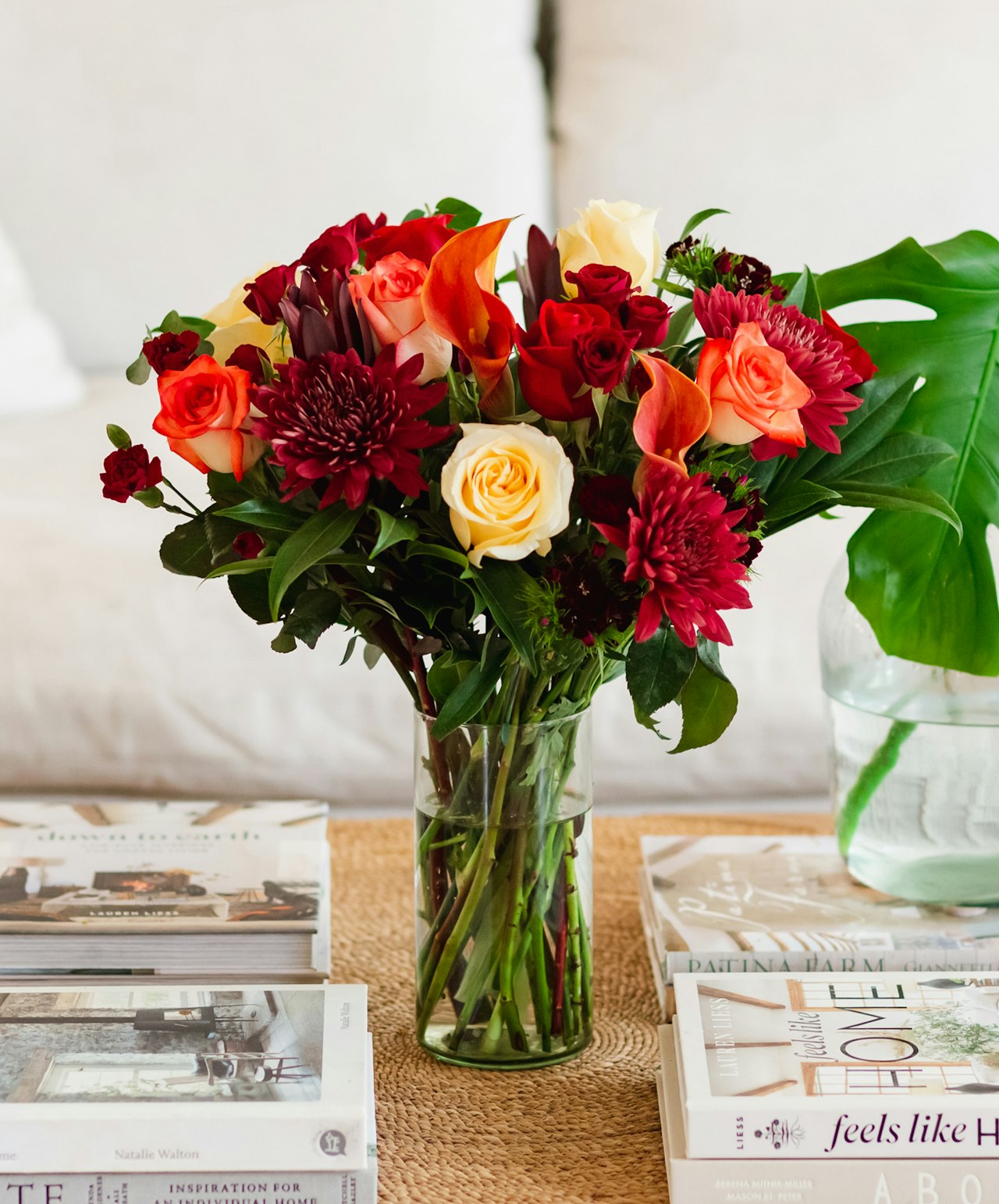 Vibrant floral arrangement featuring roses, lilies, and chrysanthemums in a glass vase.