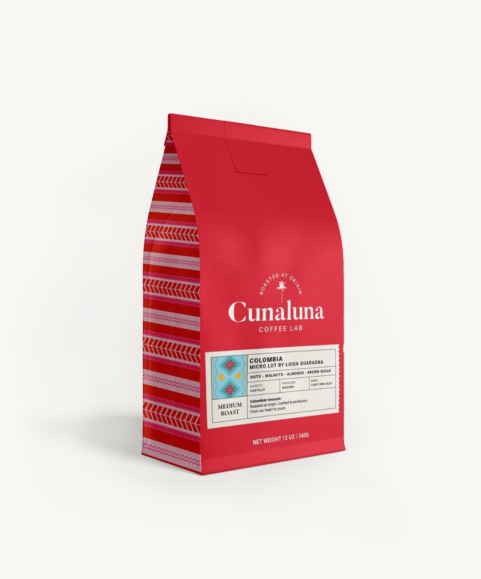Vibrant red coffee bag featuring Colombian medium roast with intricate patterns and details.