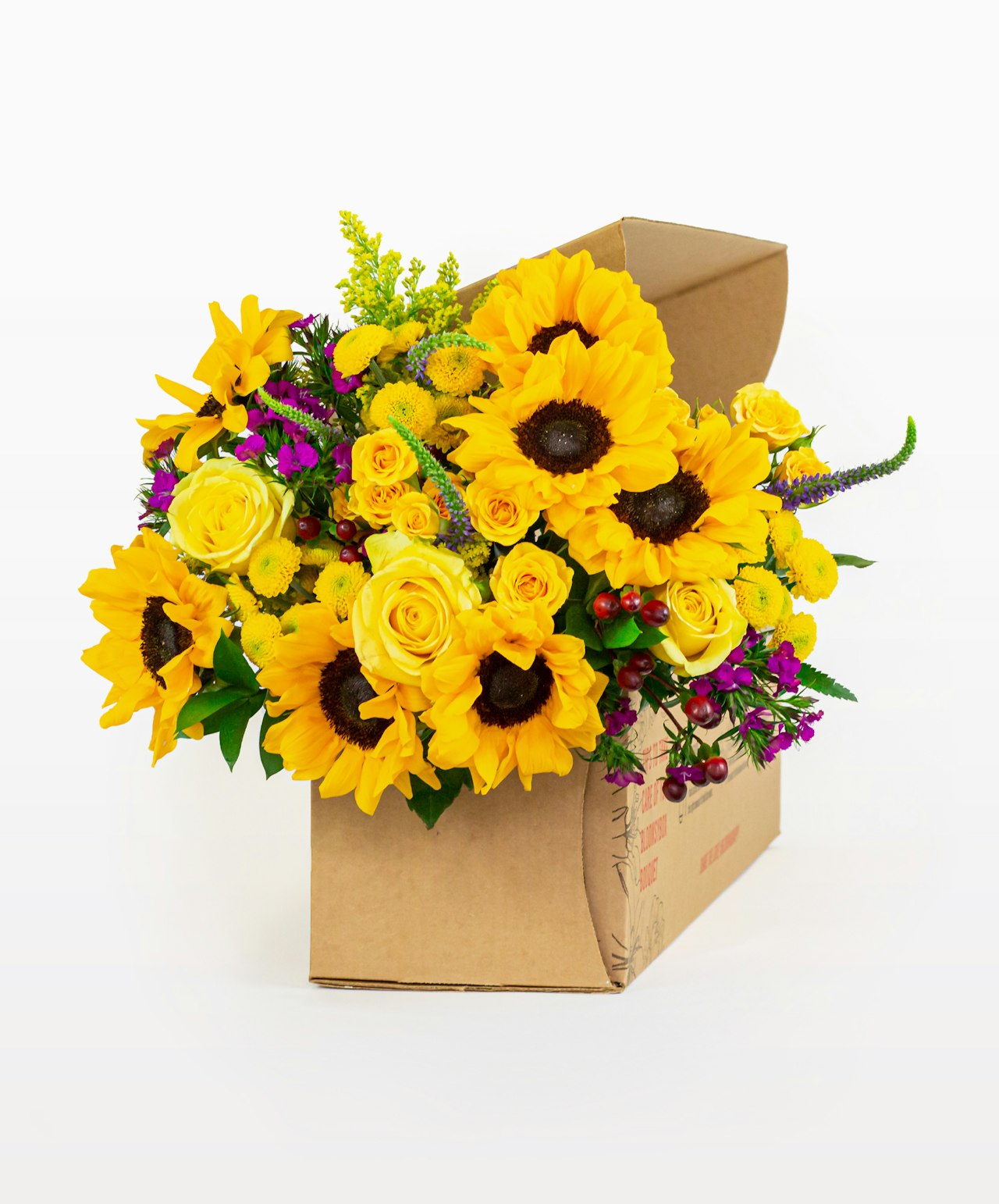 Vibrant bouquet featuring sunflowers, yellow roses, and colorful accents in a decorative box.
