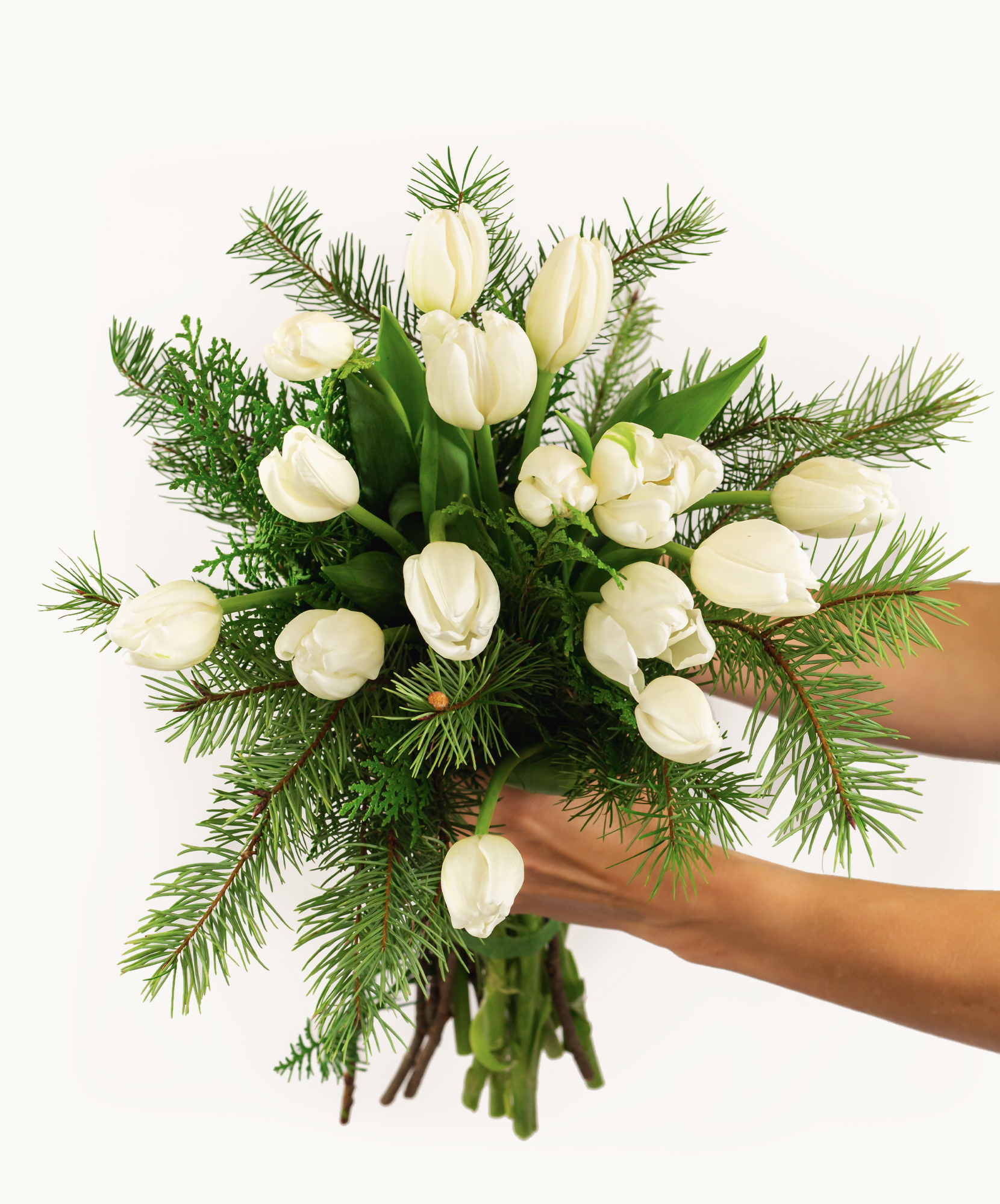Elegant bouquet of white tulips and lush greenery, perfect for celebrations.