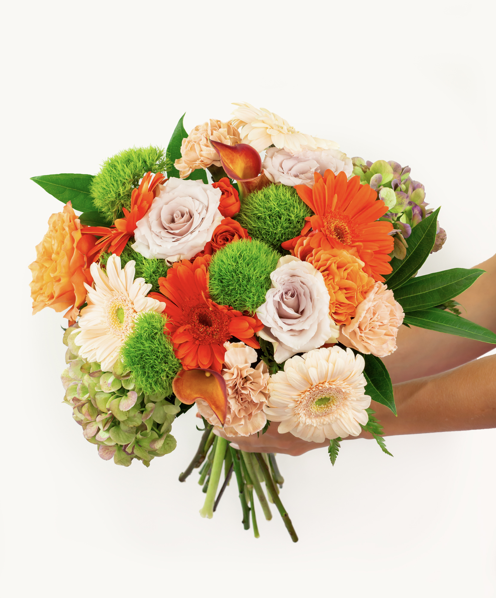 Vibrant floral bouquet featuring orange roses, gerberas, and lush greenery, ideal for celebrations.