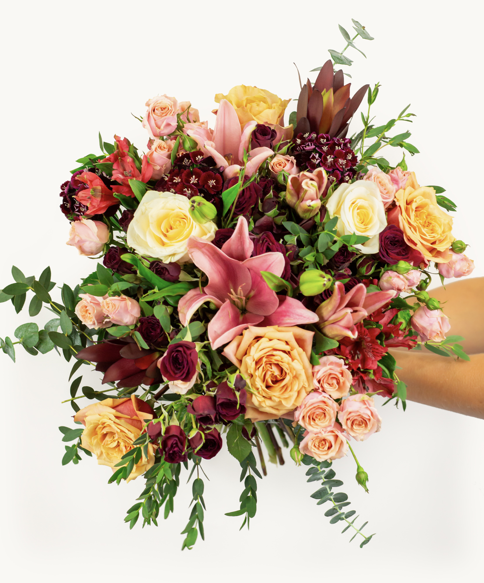 Vibrant floral bouquet featuring roses, lilies, and greenery, perfect for celebrations.