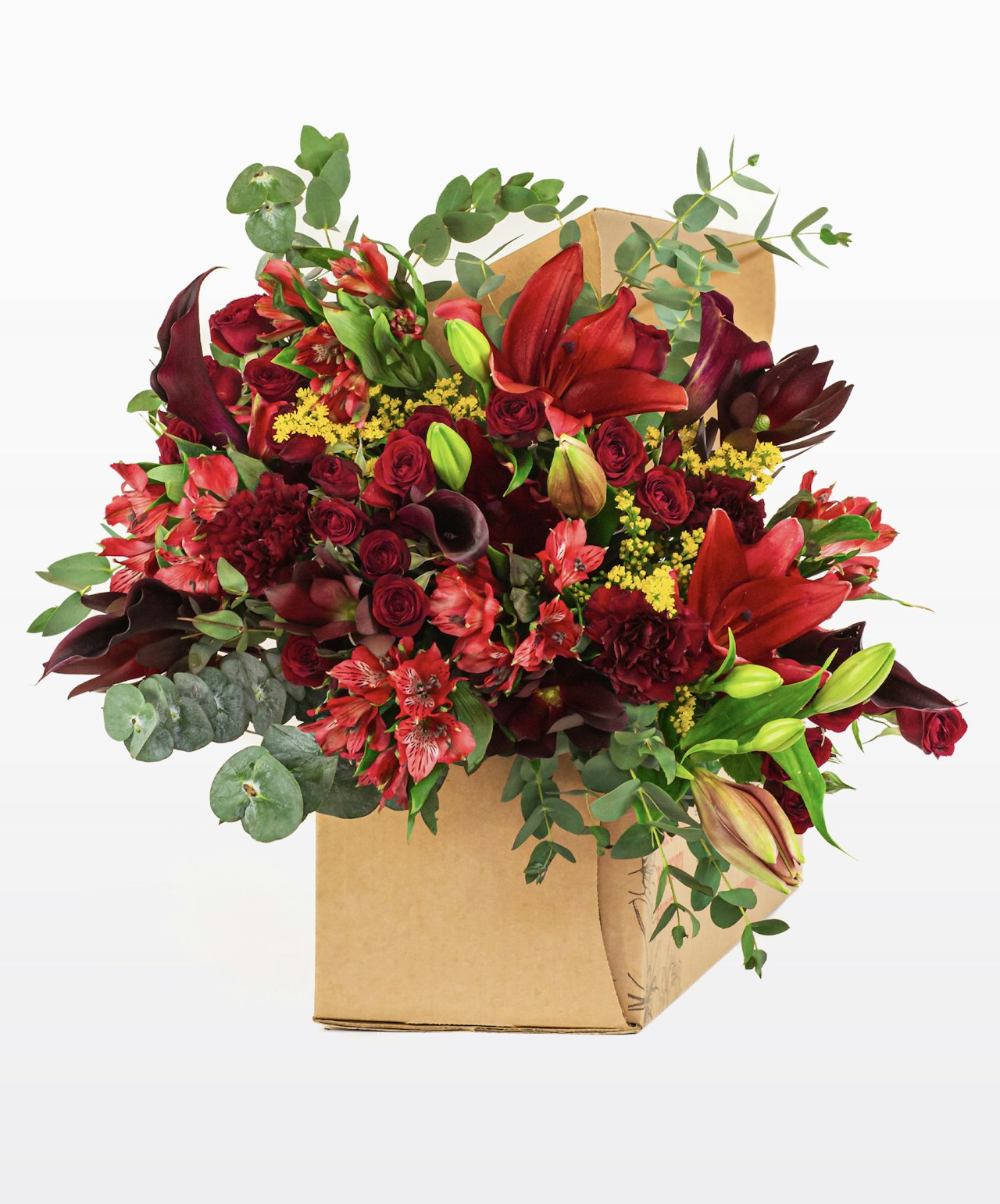 Vibrant floral arrangement in a box featuring red roses, lilies, and lush greenery.