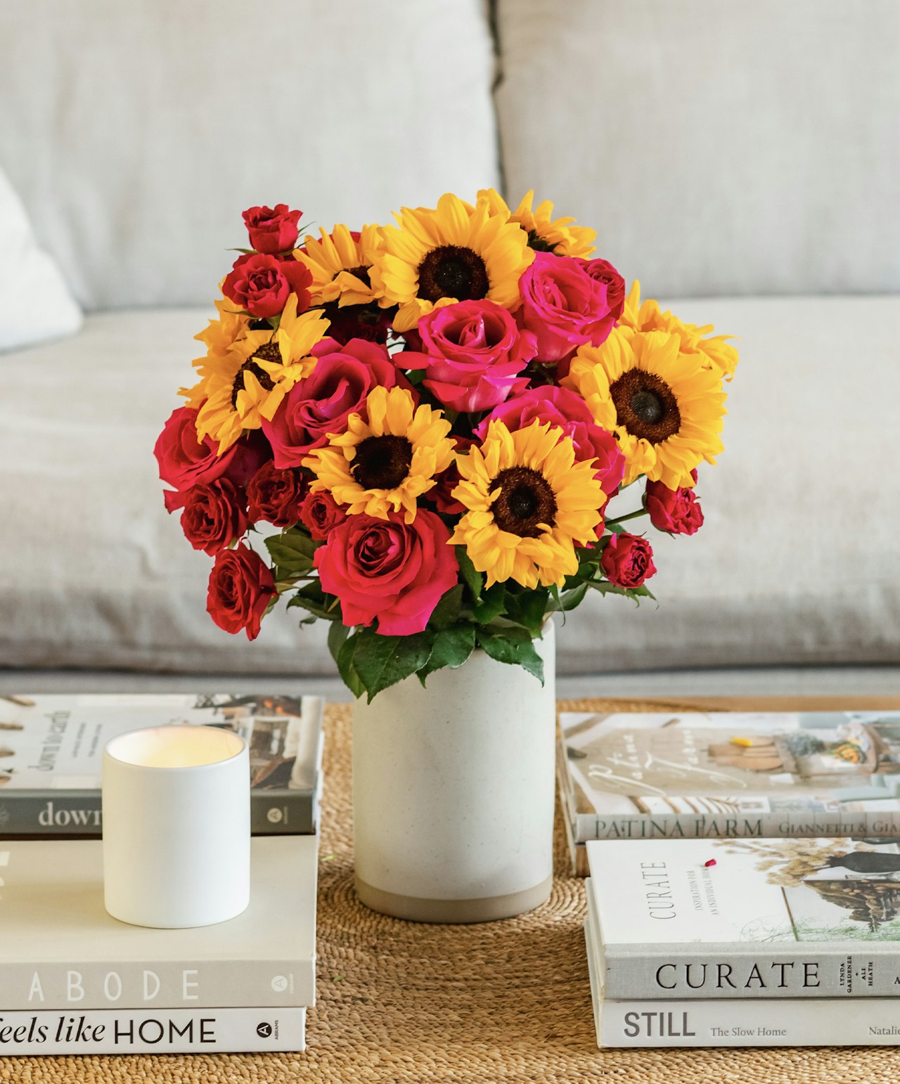 Vibrant floral arrangement of sunflowers and roses in a stylish vase, perfect for home decor.