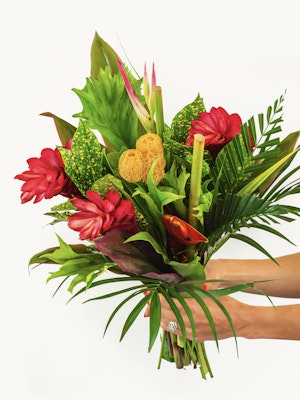 Vibrant tropical bouquet featuring red ginger flowers and lush green foliage, ideal for decor.