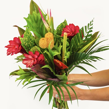 Vibrant tropical bouquet featuring red ginger flowers and lush green foliage, ideal for decor.