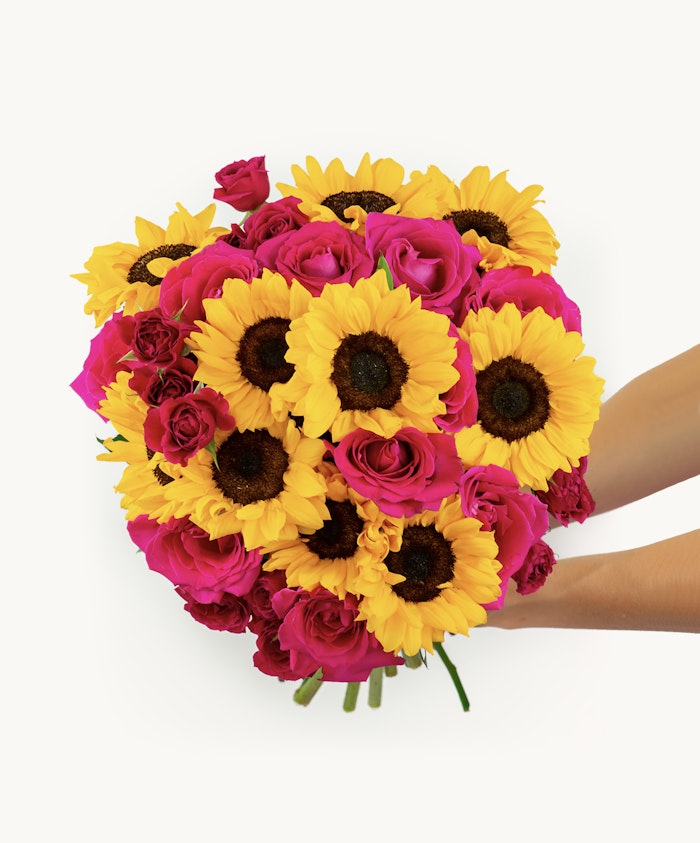 Vibrant bouquet of yellow sunflowers and pink roses, perfect for celebrations.
