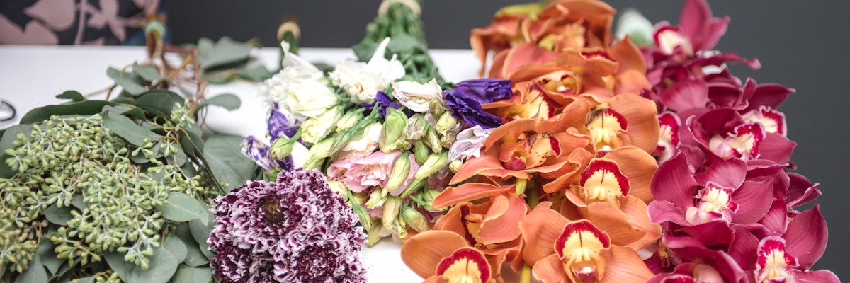 Vibrant assortment of fresh flowers, including orchids and colorful blooms, ideal for arrangements.