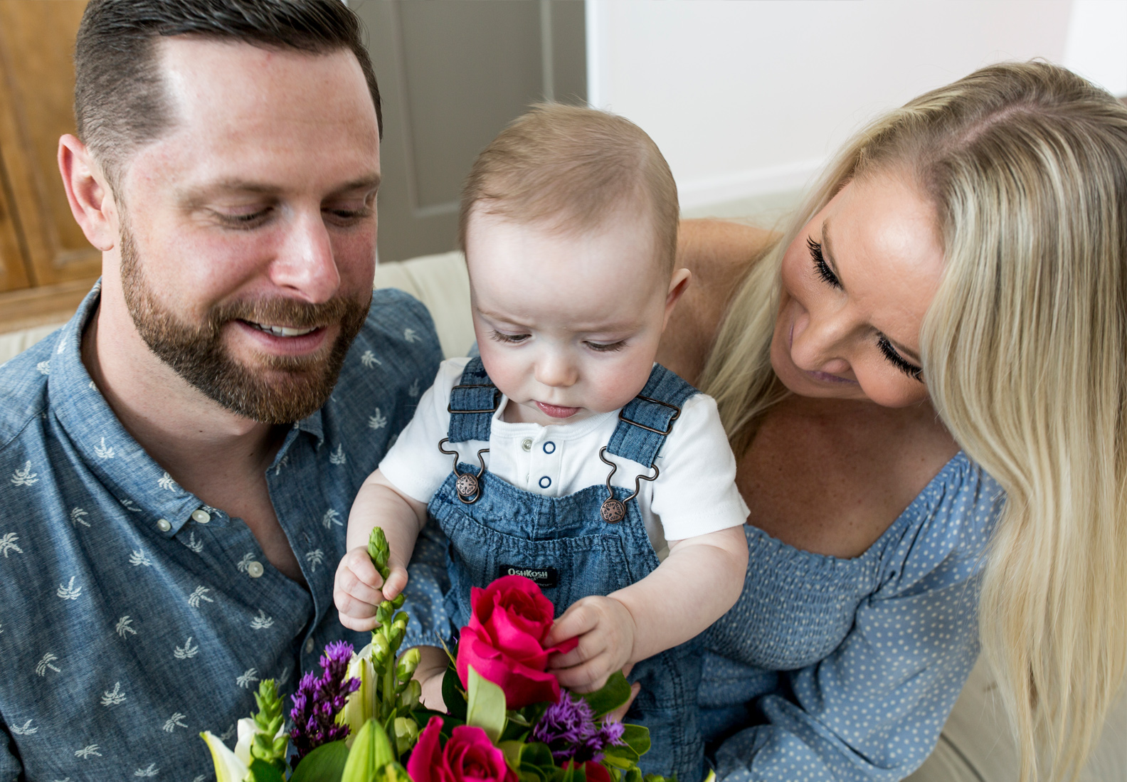 A happy family admiring a vibrant bouquet of flowers while spending quality time together.