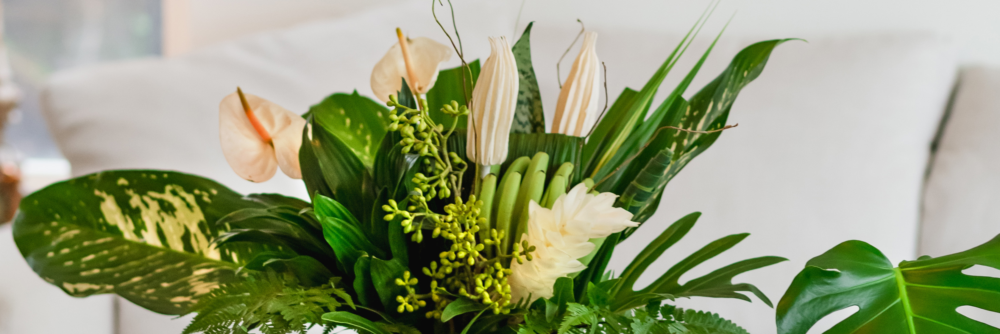 Elegant floral arrangement featuring white blooms and lush green foliage, perfect for decor.