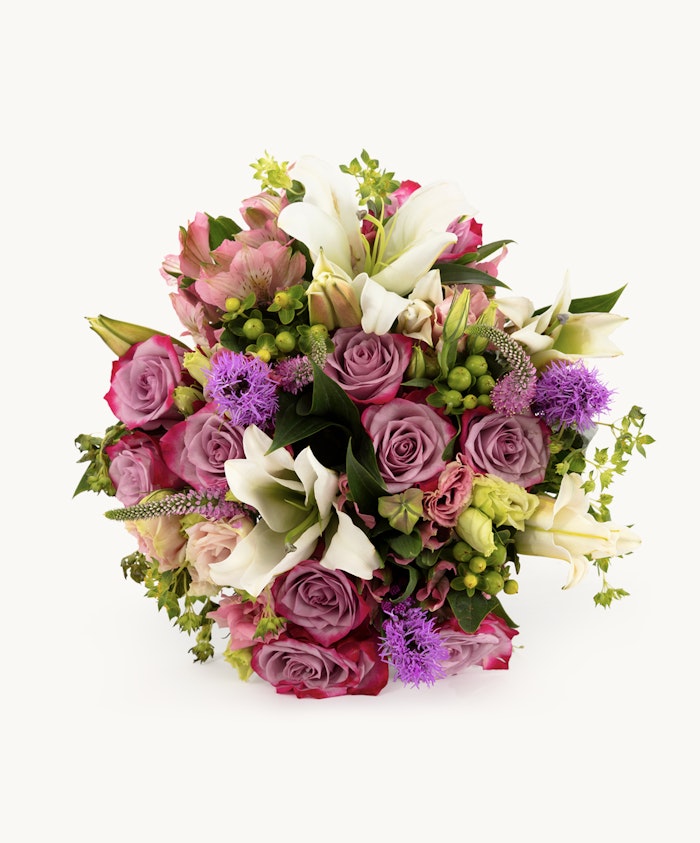 Vibrant floral bouquet featuring roses, lilies, and purple accents, perfect for any occasion.