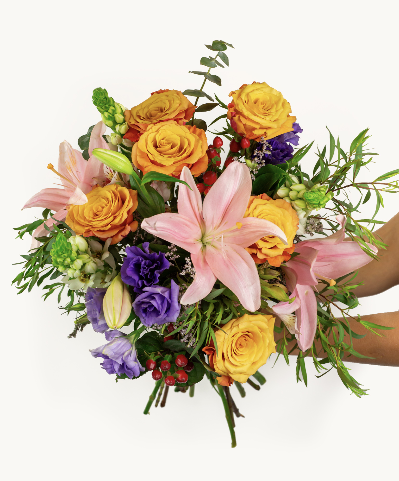 Vibrant mixed flower bouquet featuring lilies, roses, and seasonal greenery for any occasion.