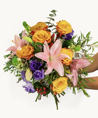 Vibrant mixed flower bouquet featuring lilies, roses, and seasonal greenery for any occasion.