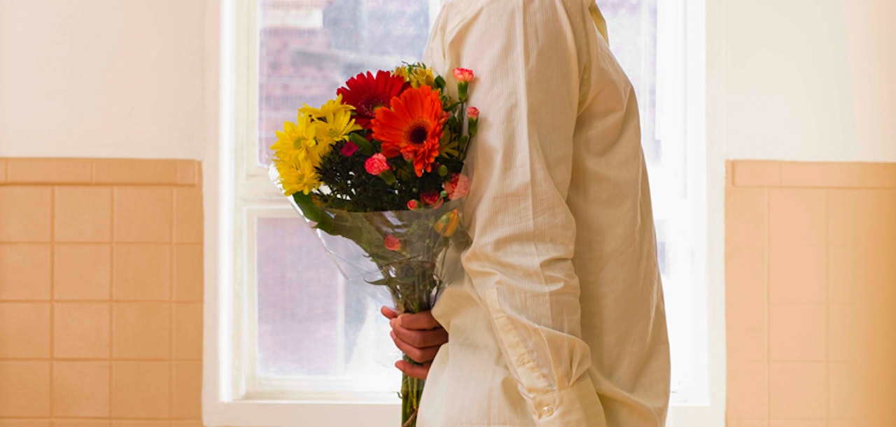 Vibrant mixed flower bouquet held by a person, adding color and charm to any setting.