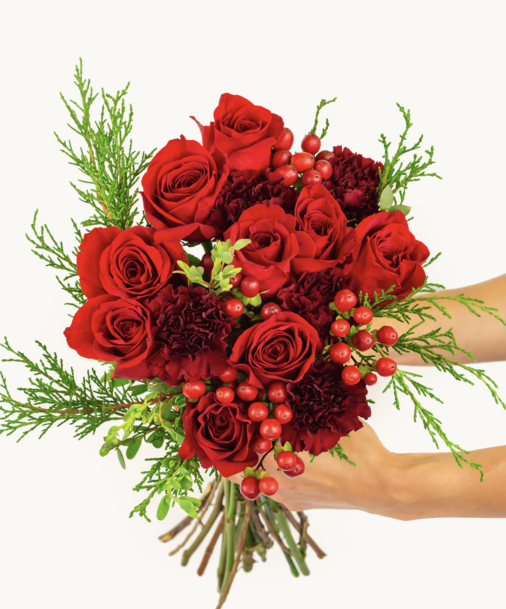 Vibrant red roses and deep maroon carnations in a lush, celebratory bouquet.