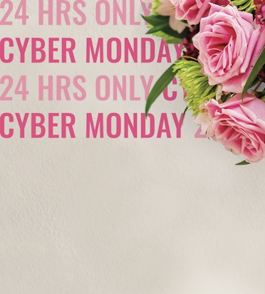 A vibrant bouquet of pink roses beside a promotional Cyber Monday sign, perfect for gifting.