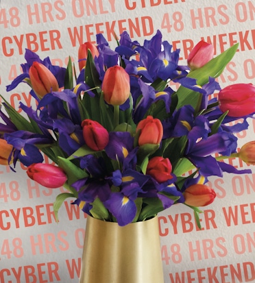 Vibrant bouquet featuring tulips and irises in a stylish vase, perfect for spring celebrations.