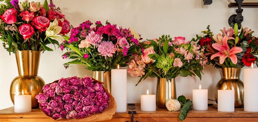 Vibrant floral display with various bouquets and candles, creating a delightful atmosphere.