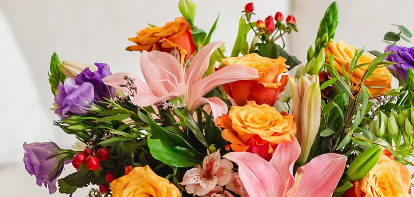 Vibrant mixed floral bouquet featuring roses, lilies, and seasonal blooms in bright colors.