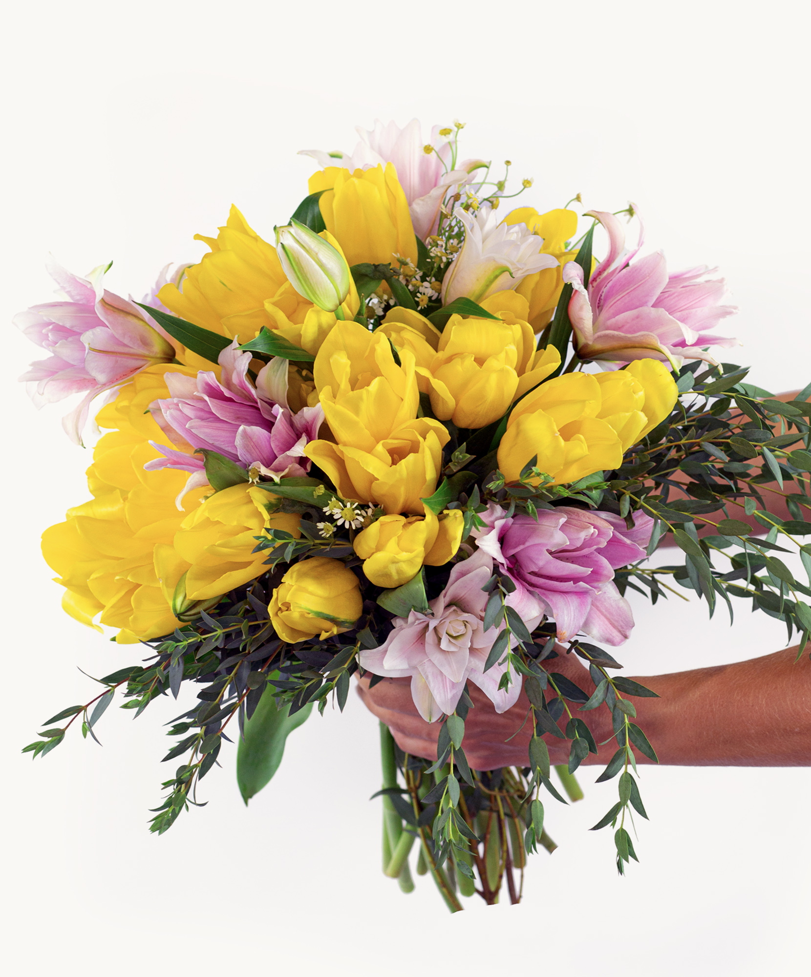 Vibrant bouquet of yellow tulips and pink flowers, perfect for spring celebrations.