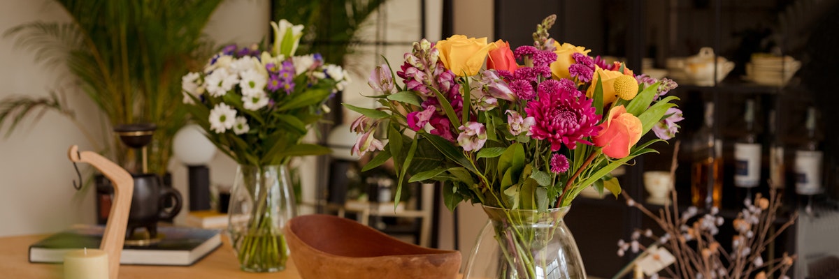 Vibrant floral bouquets featuring various colorful flowers in elegant vases, enhancing home decor.