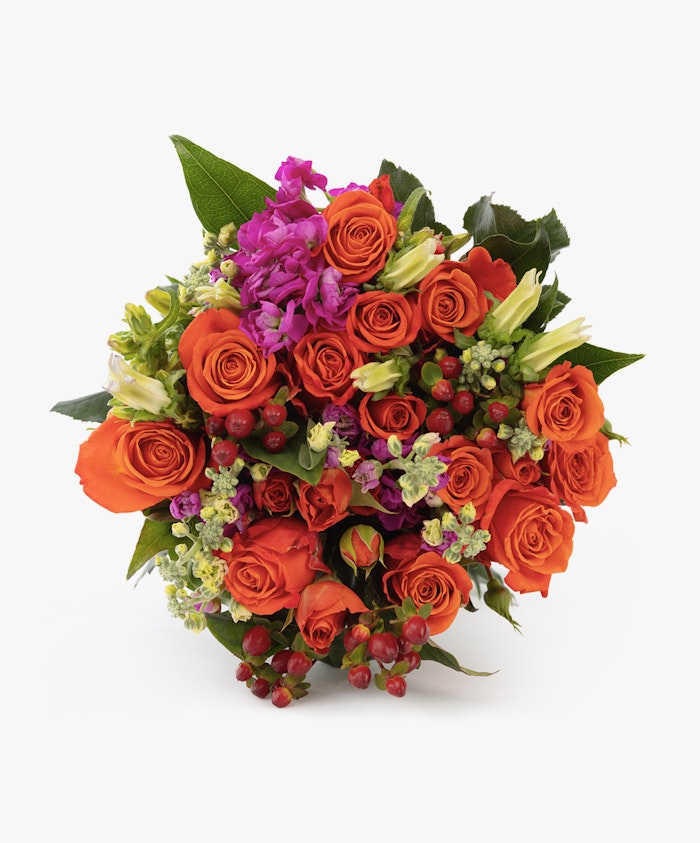 Vibrant bouquet of orange roses, green accents, and purple blooms, perfect for any occasion.