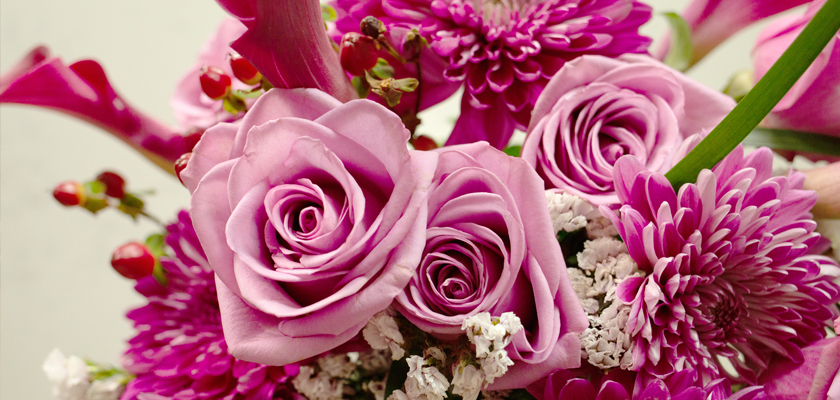Vibrant arrangement of pink roses, daisies, and seasonal blooms for special celebrations.