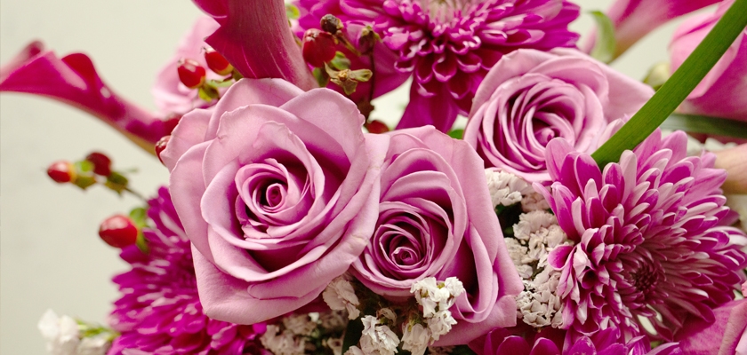 Vibrant arrangement of pink roses, daisies, and seasonal blooms for special celebrations.