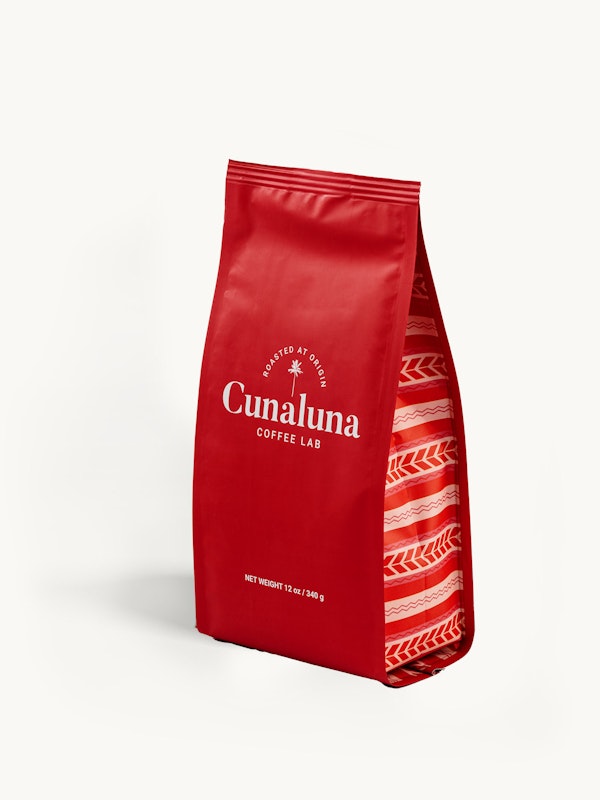Red Cunaluna Coffee Lab bag with white branding text, isolated on a white background, displaying the net weight of 12 oz (340g) with a patterned design.