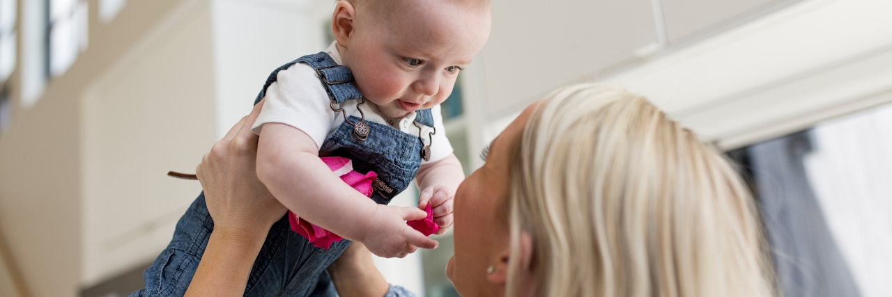 A joyful moment between a parent and child, sharing love and laughter together.