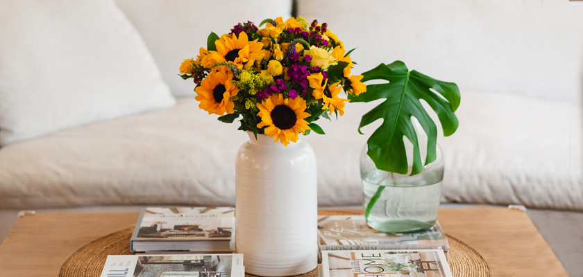 A vibrant bouquet of sunflowers and mixed flowers in a stylish vase, enhancing home decor.