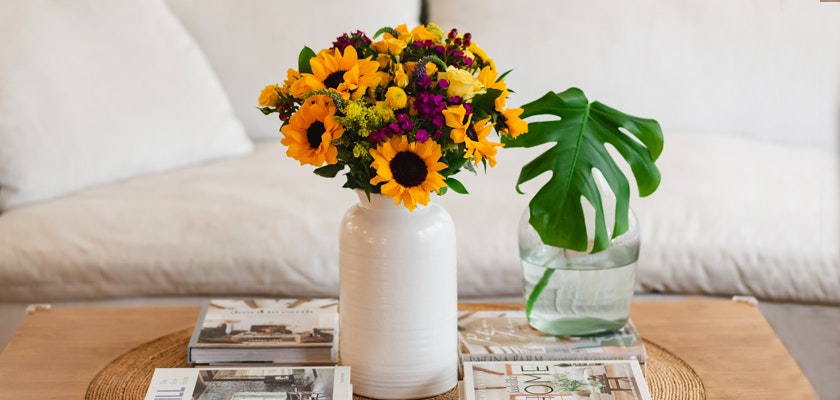 A vibrant bouquet of sunflowers and mixed flowers in a stylish vase, enhancing home decor.