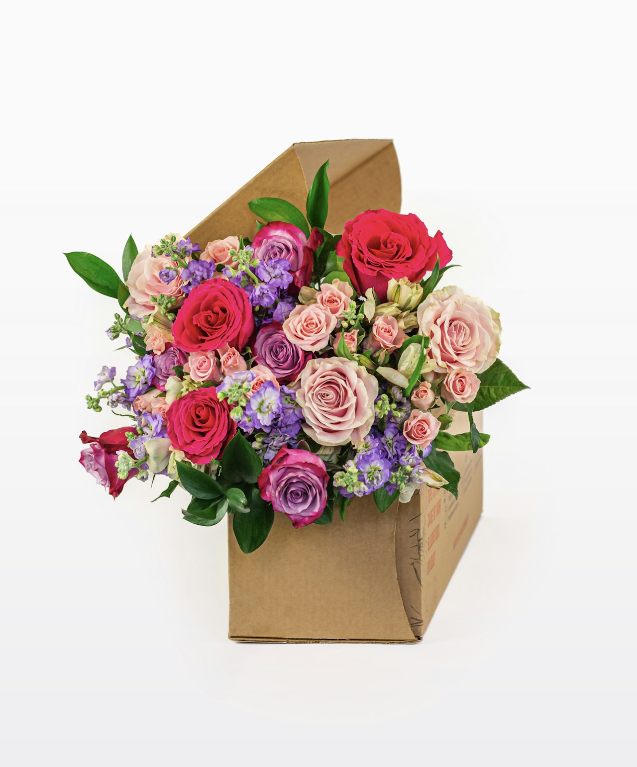 Vibrant bouquet featuring pink and purple roses, nestled in a charming gift box.