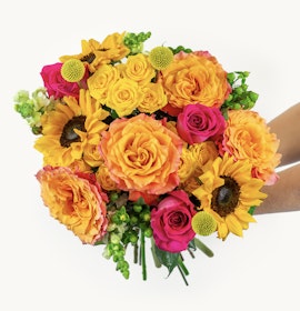 Vibrant bouquet featuring sunflowers, orange roses, and pink blooms, ideal for any celebration.