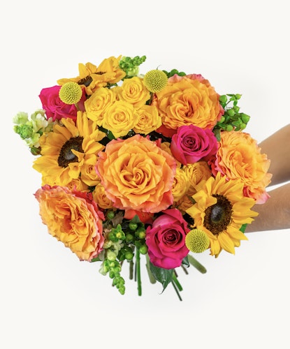 Vibrant bouquet featuring sunflowers, orange roses, and pink blooms, ideal for any celebration.