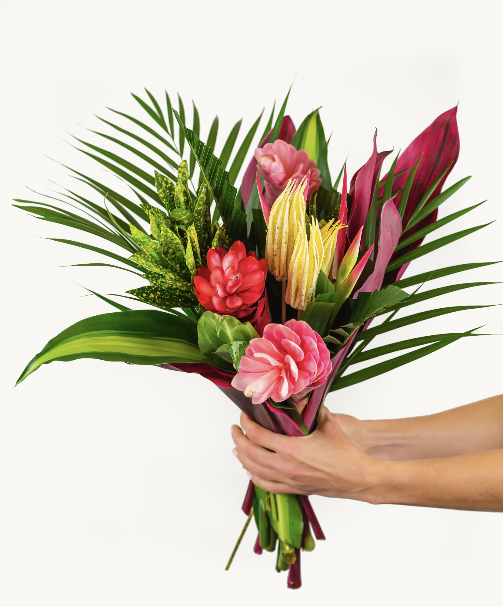Vibrant tropical flower bouquet featuring pink, red, and green foliage, ideal for celebrations.